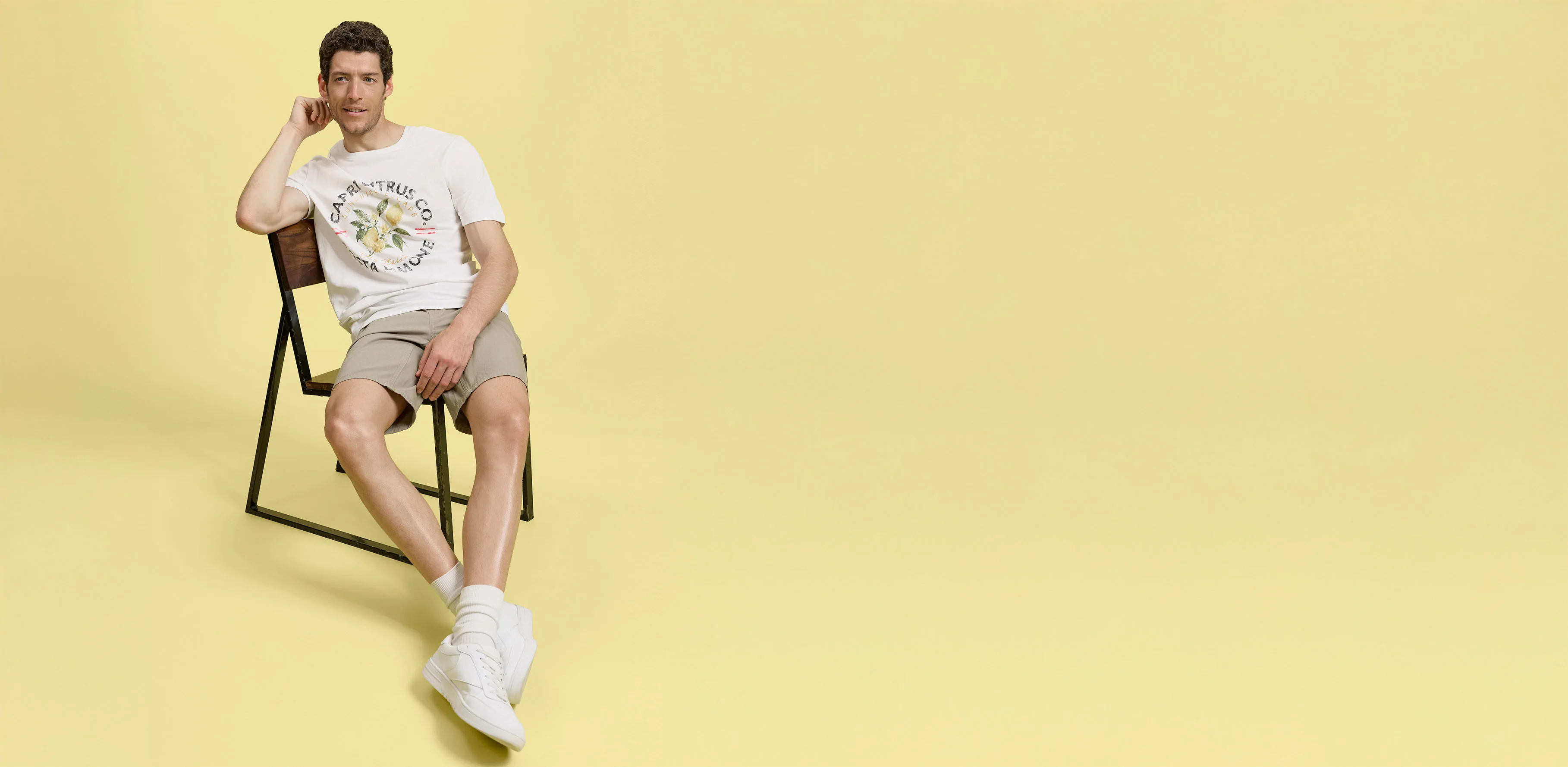 Letnie stylizacje z beżowymi szortami, białym T-shirtem i wygodnymi sneakersami.
